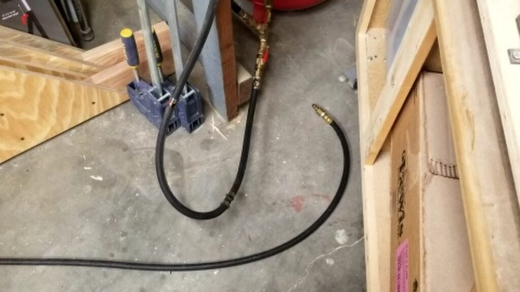The fixed air hose connected to an air compressor to pressure test the repair to ensure no leaks.