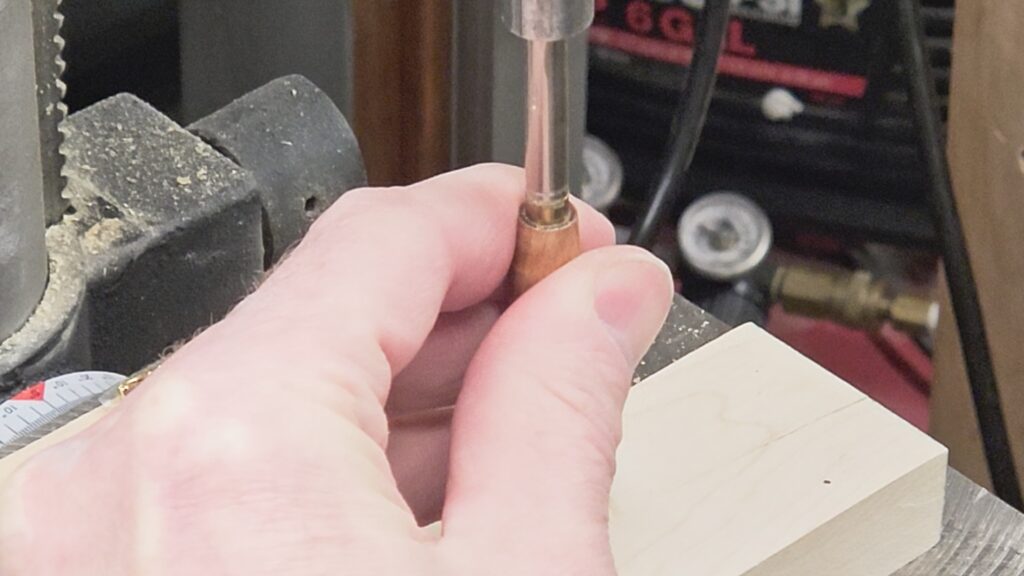 pressing the transmission into bottom half of pen blank using press