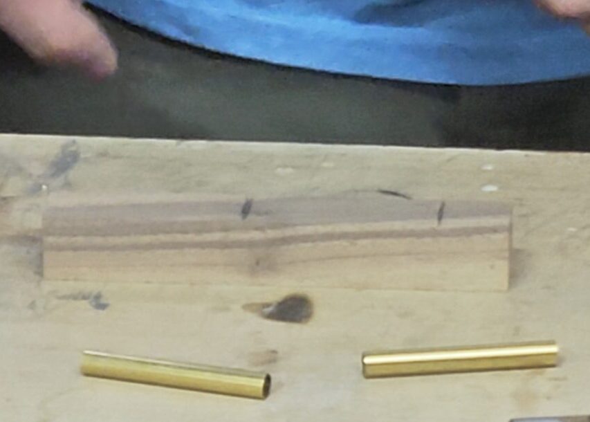 a pen blank with two pencil marks showing where to cut based on the brass tube lengths