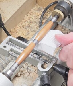 applying Renaissance Wax to polished pen blank while lathe is turning