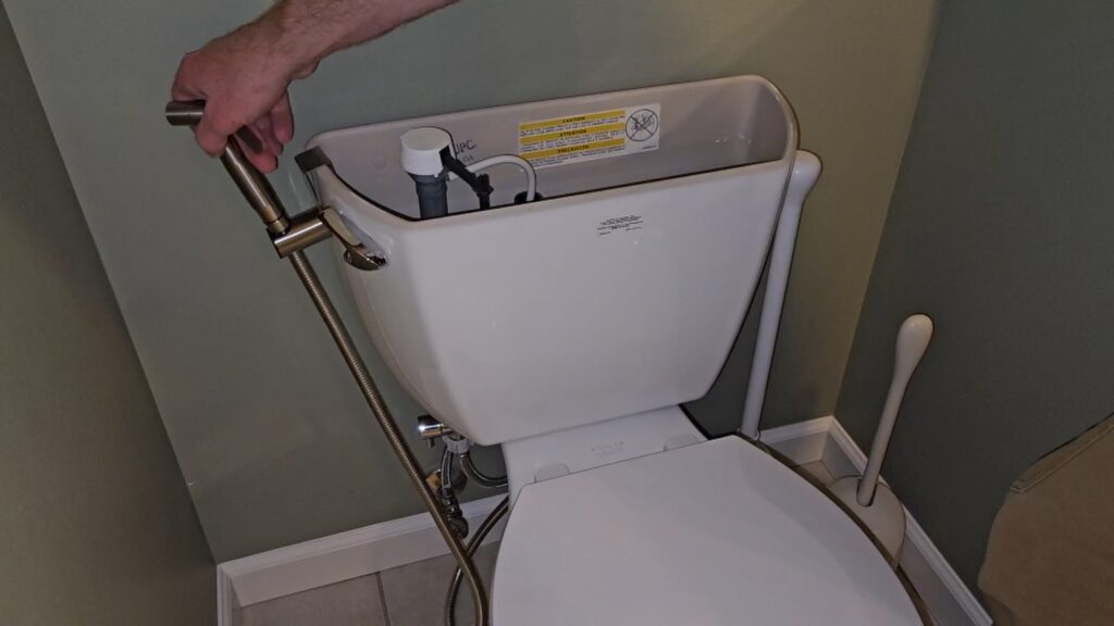 bidet sprayer mounted on toilet tank